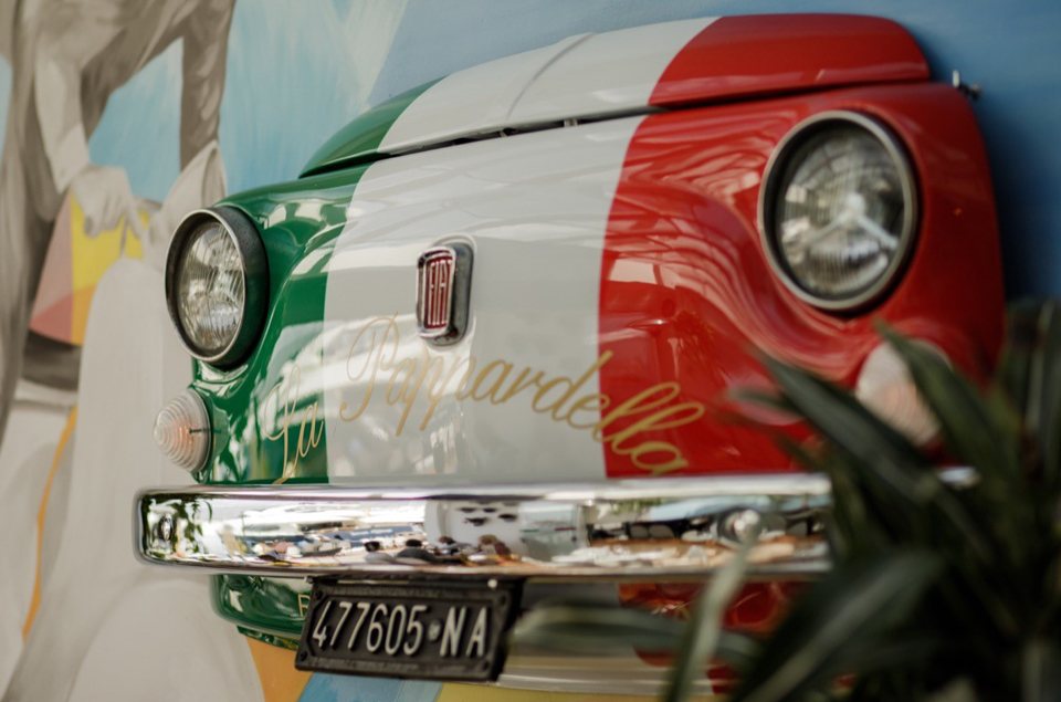 A Fiat 500 mounted on the restaurant wall in Italian tricolour with a Napoli number plate