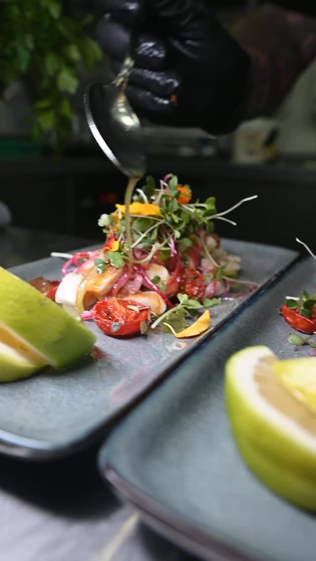 A tartare plated with micro herbs and dressing